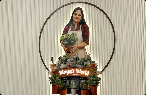 Maya holding a potted plant at the Maya's World boutique